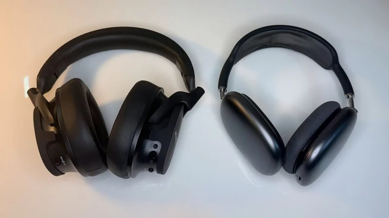 Two black over-ear headphones on a white surface; left pair bulkier with attached microphone boom, right pair sleeker with thin mesh headband and oval ear cups