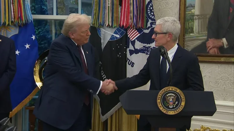 Two men in suits shake hands at a presidential podium in an ornate room, surrounded by American flags, military banners, and a large portrait on the wall
