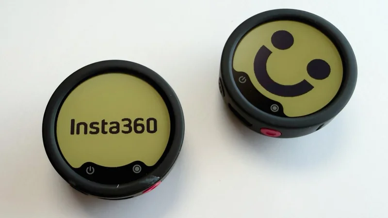 Two round Insta360 remote controls on a white surface, one displaying the Insta360 logo, the other showing a smiling face, both with black bezels and small control icons