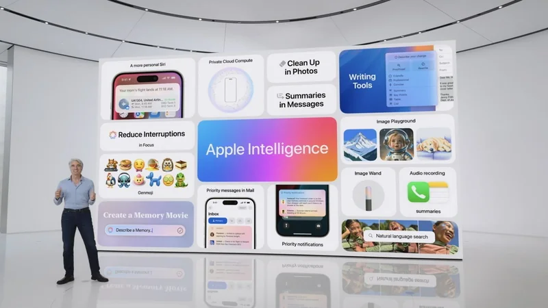 Presenter on a white stage introducing Apple Intelligence, standing before a giant colorful screen showcasing various iPhone and Mac features like writing tools, photo cleanup, call summaries, and emoji suggestions