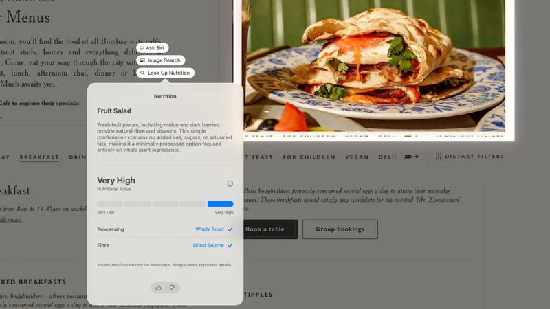 Computer screen showing a restaurant menu webpage with nutritional info popup, overlaid beside a colorful plate of stacked wraps or sandwiches filled with vegetables and other ingredients