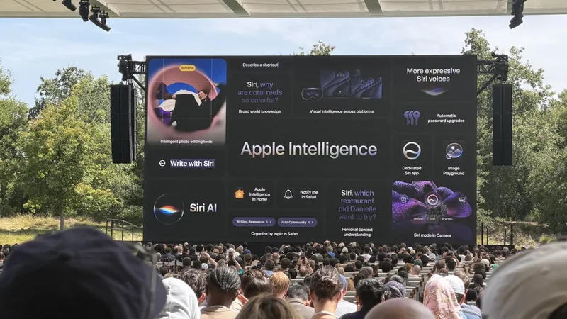 Large outdoor Apple event audience facing a giant screen presenting Apple Intelligence features, Siri AI enhancements, and colorful graphics, with trees and open sky visible in the background