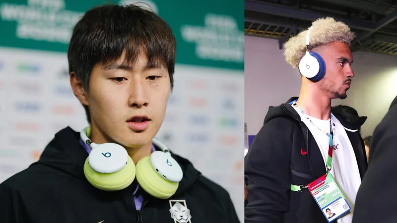 Two male athletes wear large Beats headphones around their necks and over their ears, standing in sports interview areas with accreditation badges and casual athletic clothing.