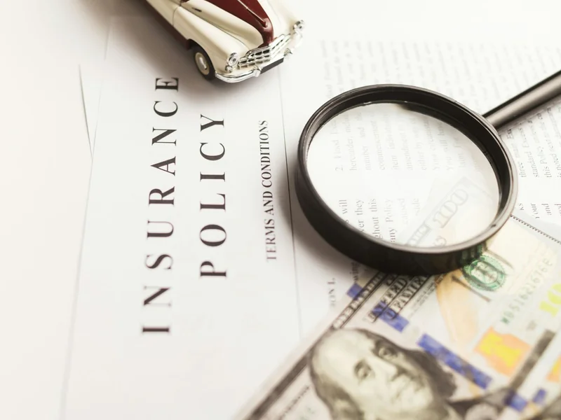 Magnifying glass on an insurance policy as Aviva has uncovered a record £230 million in insurance fraud claims and is using AI tools to counter the growing problem.