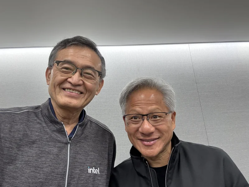 Two men smiling, one wearing an intel logo jacket.