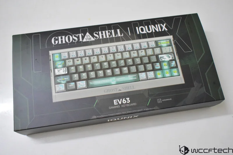 Iqunix Ghost In The Shell EV63 gaming keyboard packaging displays the keyboard with custom keycaps featuring themed graphics and branding.