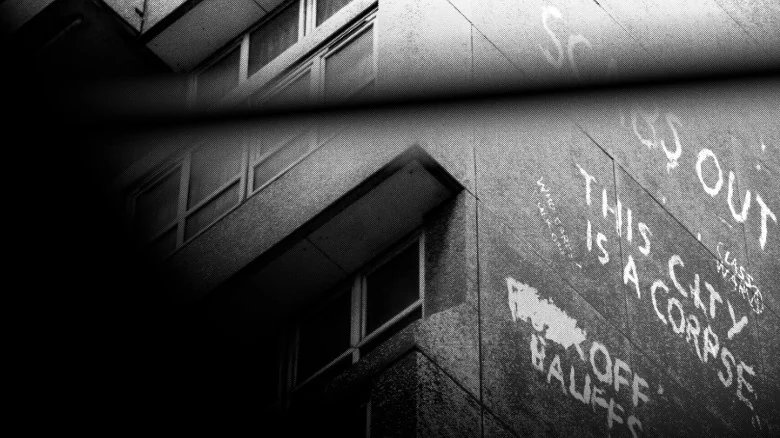 A screenshot from Signet City. A stretch of graffiti on the side of a building declares