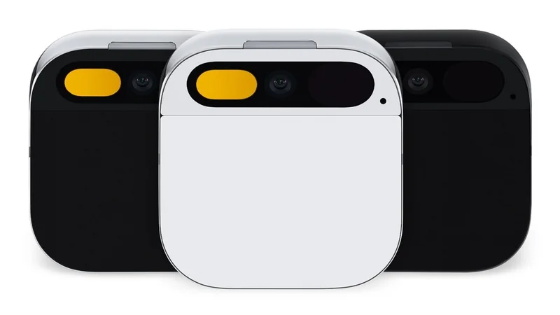 Three small square wearable camera devices, one white in front and two black behind, each with rounded corners and a horizontal pill-shaped lens area featuring a yellow accent on the left