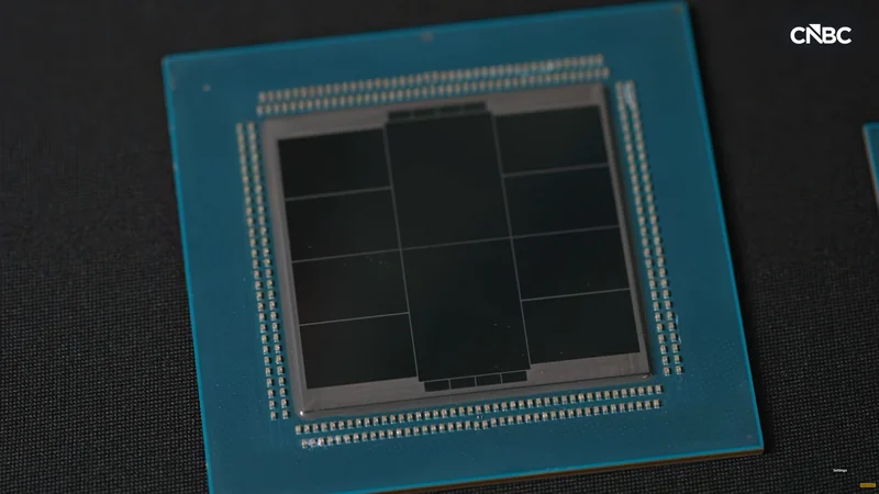 A close-up of an unidentified computer chip on a dark surface, with a 'CNBC' logo in the top right corner.