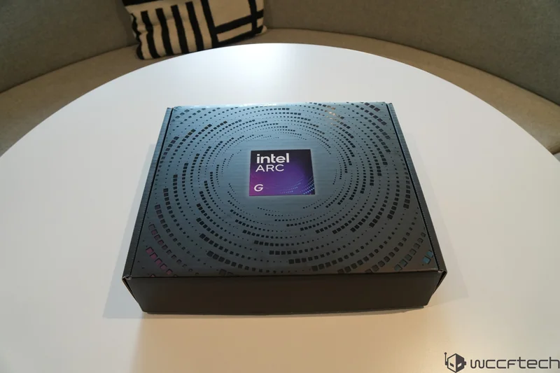 A box labeled 'Intel Arc G' is resting on a round white table.