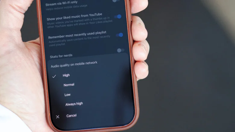 Closeup of an iPhone, showing the streaming quality menu in the YouTube Music app
