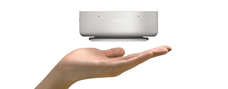 A Lenovo YOGA device levitating above a person's hand.