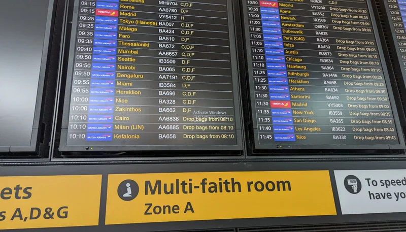 Heathrow airport departure boards display flight information with a Windows activation watermark on screen.