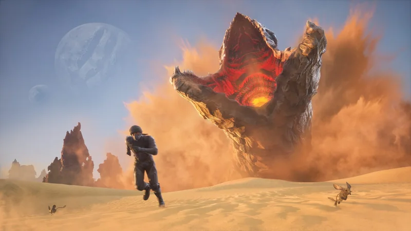 A soldier in armor running across a desert landscape as a massive sand creature with a fiery interior emerges from the ground.
