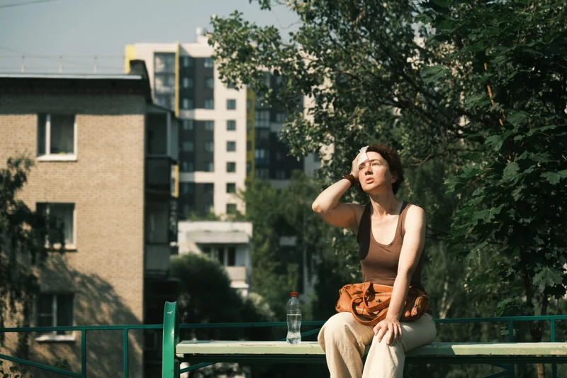 Woman is feeling bad during the heat wave in city