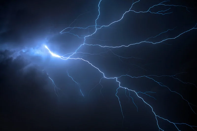 Image of a branched lightning bolt against a dark sky.