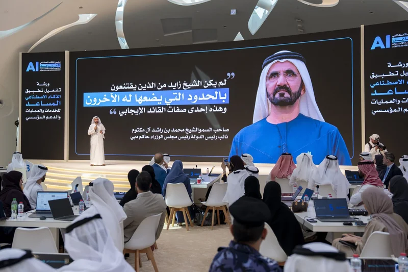 Officials at laptops during a UAE government workshop on agentic AI, with Agentic AI for UAE Government branding on screen