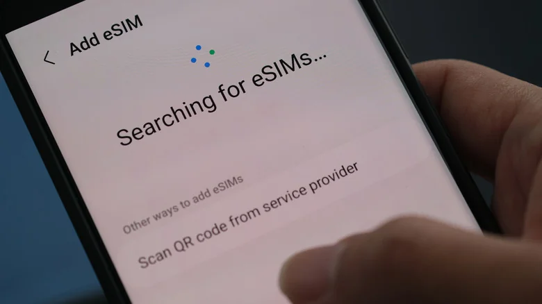 "Searching for eSIMS" message on a smartphone.