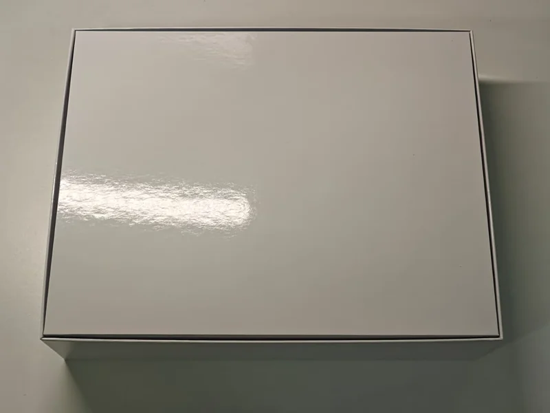 A plain white, unbranded laptop box on a table.