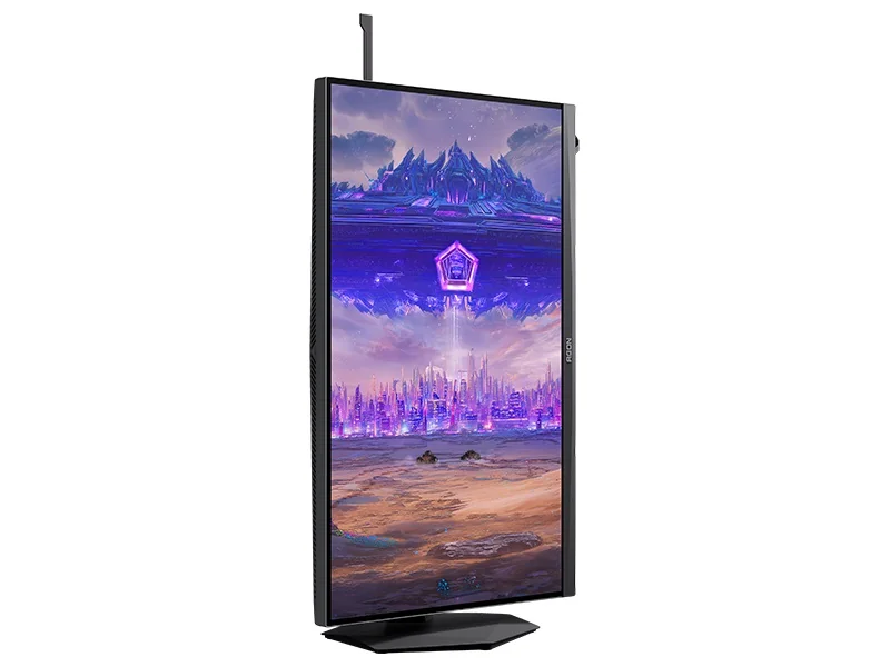 AOC AGON monitor displaying a futuristic cityscape in portrait orientation.