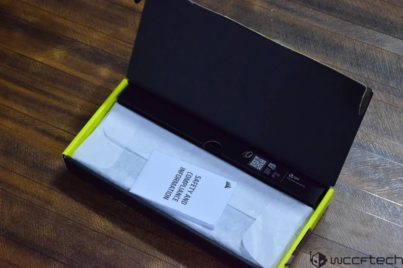 An open Corsair product box displaying a booklet labeled 'SAFETY AND COMPLIANCE INFORMATION'.