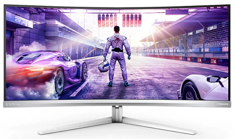 A Philips Evnia curved monitor displays a racing game with a driver in the foreground holding a helmet on a racetrack.
