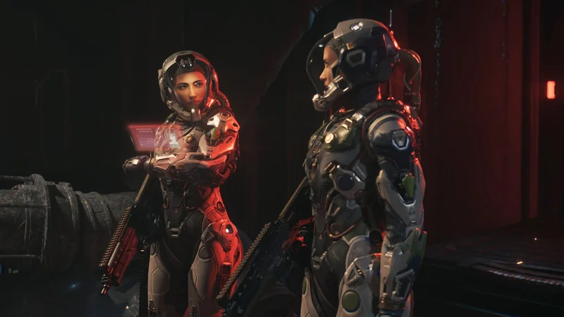 Two characters in futuristic armored suits stand facing each other, one holding a glowing weapon, in a dimly lit sci-fi environment.