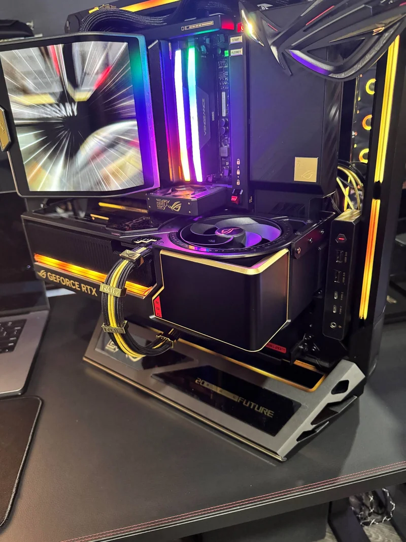 An ASUS ROG gaming setup featuring a visible Corsair Vengeance RAM with RGB lighting and an NVIDIA GeForce RTX graphics card on a '20XX Future' stand.