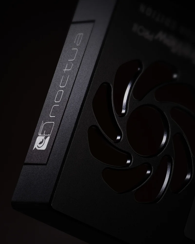 A close-up of a Noctua cooling fan with the brand name and logo visible on the side.