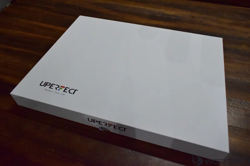 A white box with the UPERFECT logo and the slogan 'Perfect Your Life' on a wooden surface.