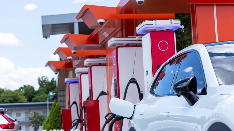 A row of DC Level 3 fast chargers with an EV charging in the foreground