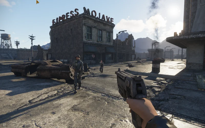 A first-person view of a character holding a pistol in the game Fallout: New Vegas, standing in front of a building with a sign reading 'EXPRESS MOJAVE' in a desolate post-apocalyptic setting.